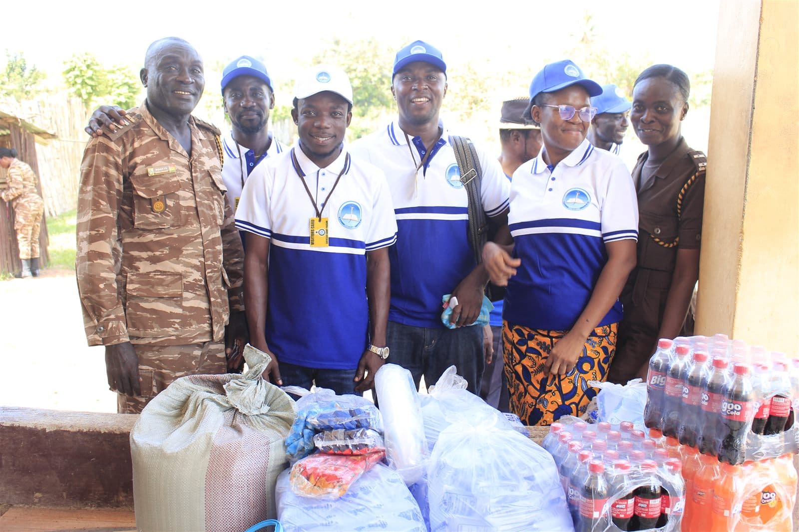 Bethel Inspiration team members and prison officers standing behind the donated items